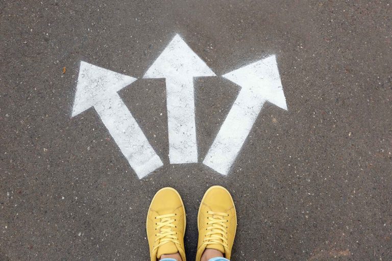 woman-standing-near-arrows-students-waiting-for-clinical-placement-nurseclick-1800×1200