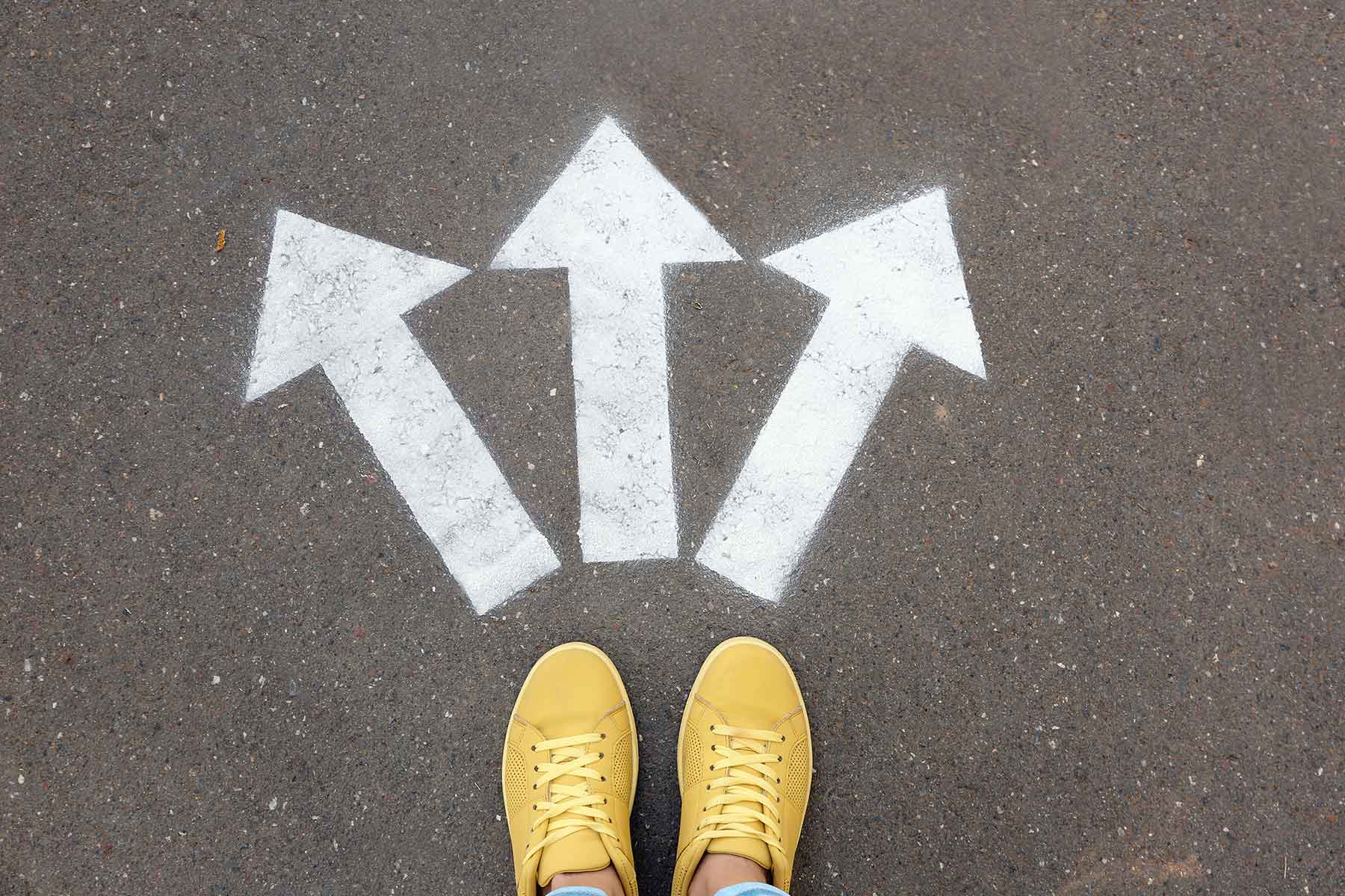 woman-standing-near-arrows-students-waiting-for-clinical-placement-nurseclick-1800×1200